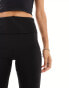 Bershka Petite folded waistband flared trousers in black