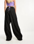 Nicce alia wide leg cargo trousers in black with side hem split