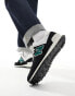 New Balance 574 trainers in black and green